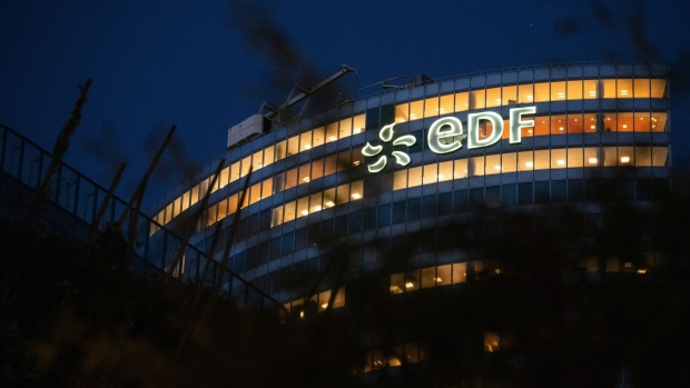 An illuminated logo on the Electricite de France (EDF) headquarters at dawn in the La Defense business district in Paris.