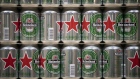 Red star logos sit on Heineken beer cans, stacked at the Heineken NV brewery in Zoeterwoude, Netherlands, on Wednesday, May 30, 2018. Heineken has acquired Stellenbrau, a beer maker based in South Africa's western Cape, submitted a bid for a local Coca-Cola bottler and built a brewery in Ivory Coast to take on market leader Castel.