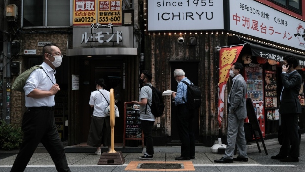 Customers line up in front of a restaurant in the Shinjuku district of Tokyo, Japan, on Friday, May 28, 2021. The Japanese government recommended extending a state of emergency that includes Tokyo and other major cities, trying to rein in coronavirus infections ahead of the capital hosting the Olympics in less than two months. Photographer: Soichiro Koriyama/Bloomberg