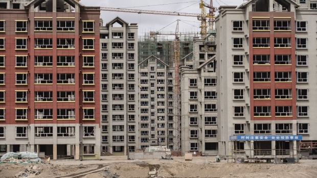 Residential buildings under construction in the new city area of Yumen, Gansu province, China, on Wednesday, March 31, 2021. Yumen, "the cradle of China's oil industry," has become a totem for China's changes over the past four decades—from a time of sacrifice and ideology to one of entrepreneurs and the pursuit of wealth, from the old economy to the new, from fossil fuels to renewable energy. Photographer: Qilai Shen/Bloomberg