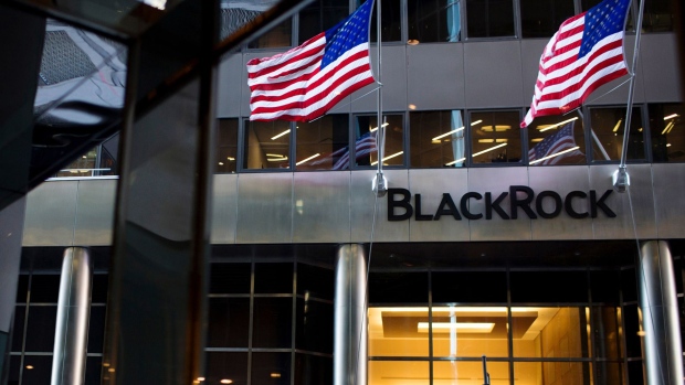 Pedestrians pass in front of BlackRock Inc. headquarters in New York. Photographer: Gabriella Angotti-Jones/Bloomberg
