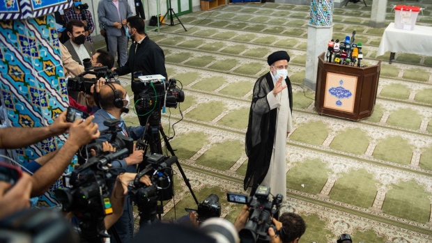 Ebrahim Raisi, judiciary chief, acknowledges the media after casting his vote in the Iranian presidential election in Tehran, Iran, on Friday, June 18, 2021. The stage-managed elevation of Raisi, 60, carries risks for the country’s guiding hand, Supreme Leader Ali Khamenei, given the ayatollah’s desire to quickly rid Iran of U.S. sanctions and a history of political unrest.