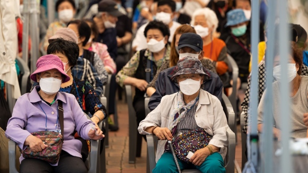 Elderly residents wait to receive a dose of the Pfizer-BioNTech Covid-19 vaccine outside a vaccination site at the Guro Arts Valley Theater in the Guro district of Seoul, South Korea, on Tuesday, June 8, 2021. South Korea is planning to use Covid-19 vaccines from Moderna Inc. and Johnson & Johnson from this month, in addition to the current supplies from Pfizer Inc. and Astrazeneca Plc.