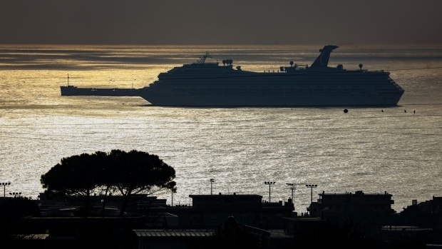 The Carnival Valor cruise ship, operated by Carnival Corp., silhouetted while docked at the port of Civitavecchia near Rome, Italy, on Monday, Feb. 22, 2021. The cruise industrywide stock surge has been all the more extraordinary because the companies have had almost no paying customers for the past year, and they’ve had to assume piles of high-interest debt just to get by. Photographer: Alessia Pierdomenico/Bloomberg