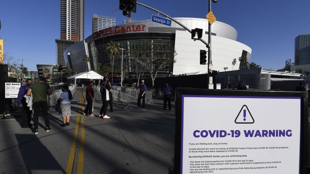 Ushers check the vaccination cards or recent Covid-19 test results of arriving fans at the Staples Center in Los Angeles, on April 18. Photographer: Kevork Djansezian/Getty Images