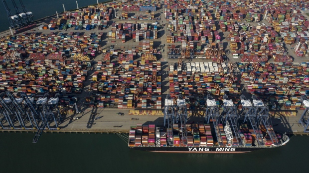 A Yang Ming Marine Transport Corp. container ship sits anchored at the Yantian International Container Terminals, operated by CK Hutchison Holdings Ltd.'s Hutchison Port Holdings Trust (HPH Trust), in this aerial photograph taken in Shenzhen, China, on Friday, Sept. 6, 2019. Shenzhen is young, hopeful and looks optimistically toward a future where it can help drive China’s push to dominate the next century through an innovative economy that sidesteps political freedoms. The city also has the centralized control, relentless efficiency and advanced manufacturing that lie at the root of President Xi Jinping’s concept of China’s future greatness. Photographer: Qilai Shen/Bloomberg