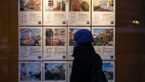 A pedestrian views property details on display in an estate agents' window in Copenhagen, Denmark, on Thursday, Jan. 3, 2019. For the first time in almost three years, the central bank of Denmark has bought kroner to support its euro peg through a direct intervention in the currency market.