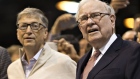 Warren Buffett, chairman and chief executive officer of Berkshire Hathaway Inc., center right, and Bill Gates, billionaire and co-founder of the Bill and Melinda Gates Foundation, center left, watch a newspaper toss outside a Clayton Homes Inc. display on the exhibit floor ahead of the Berkshire Hathaway annual meeting in Omaha, Nebraska, U.S., on Saturday, May 6, 2017. Buffett said during the Berkshire investors gathering that he's more inclined than usual this year to sell some assets because the tax advantage could soon diminish for divesting securities at a loss.