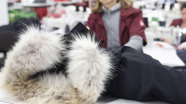 An employee checks a finished jacket with a fur collar at the new Canada Goose Inc. manufacturing facility in Montreal, Quebec, Canada, on Monday, April 29, 2019.