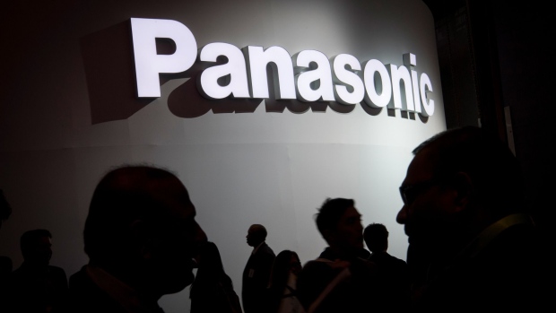 Attendees walk past a Panasonic Corp. booth during the 2018 Consumer Electronics Show (CES) in Las Vegas, Nevada, U.S., on Wednesday, Jan. 10, 2018. Electric and driverless cars will remain a big part of this year's CES, as makers of high-tech cameras, batteries, and AI software vie to climb into automakers' dashboards. Photographer: David Paul Morris/Bloomberg