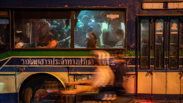 Commuters wearing protective face masks ride a bus in Bangkok, Thailand, on Friday, May 14, 2021. Thailand plans to inoculate the majority of the adult population in Bangkok in the coming months to quell a flareup in virus infections that's made the capital city the epicenter of the nations biggest Covid-19 outbreak. Photographer: Nicholas Axelrod/Bloomberg