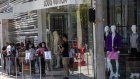 Shoppers outside a Louis Vuitton store, operated by LVMH Moet Hennessy Louis Vuitton SE, on Rodeo Drive in Beverly Hills, California, U.S., on Tuesday, June 15, 2021. California lifted most of its Covid-19 restrictions Tuesday as part of a grand reopening in which the state will end capacity limits, physical distancing and mask requirements for those that are vaccinated. Photographer: Jill Connelly/Bloomberg