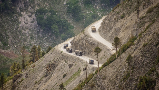 An Indian army convoy travels through Zoji La, a high mountain pass bordering China, in Ladakh, India, on June 13. Photographer: Yawar Nazir/Getty Images