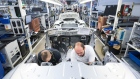 Employees work on the interior of an Aston Martin DB11 automobile on the production line at the Aston Martin Lagonda Ltd. manufacturing and assembly plant in Gaydon, U.K., on Tuesday, Sept. 4, 2018. Aston Martin is preparing to list its shares in London after the brand synonymous with U.K. spymaster James Bond pulled off a multi-year turnaround. Photographer: Chris Ratcliffe/Bloomberg