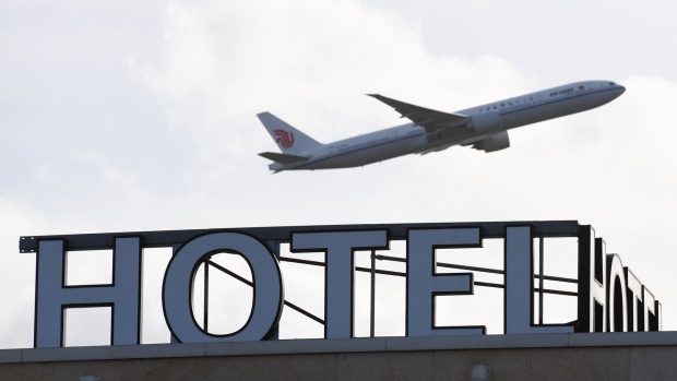 An aircraft flies over the Sofitel at London Heathrow Airport in London, U.K., on Monday, Feb. 15, 2021. Some passengers traveling to the U.K. will face tougher quarantine measures, including enforced stays in hotels, repeated tests, and the threat of fines and even jail. Photographer: Chris J. Ratcliffe/Bloomberg