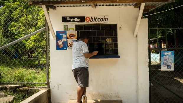 A person purchases a bottle of Coca-Cola from a shop that accepts Bitcoin in El Zonte, El Salvador, on Monday, June 14, 2021. El Salvador has become the first country to formally adopt Bitcoin as legal tender after President Nayib Bukele said congress approved his landmark proposal.