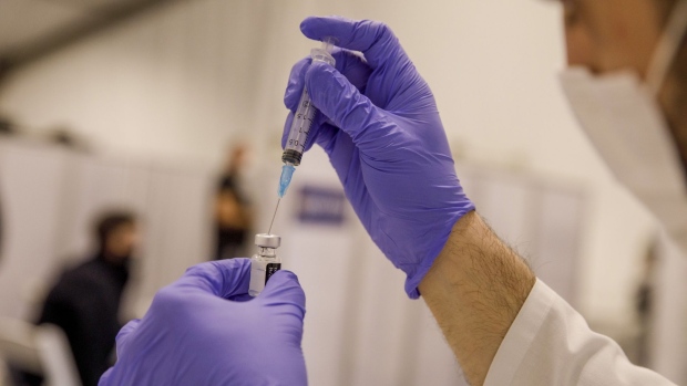 A nurse prepares a dose of the Pfizer-BioNTech Covid-19 vaccine inside a Covid-19 mass vaccination center at Rabin Square in Tel Aviv, Israel, on Monday, Jan. 4, 2020. Israel plans to vaccinate 70% to 80% of its population by April or May, Health Minister Yuli Edelstein said on Monday, pressing ahead with a program that promises an earlier-than-forecast economic recovery.
