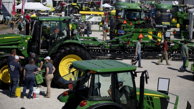 Attendees view Deere & Co. John Deere brand agricultural equipment at the company's booth during the Farm Progress Show in Decatur, Illinois, U.S., on Wednesday, Aug. 28, 2019. American agricultural groups are pushing Donald Trump to swiftly boost quotas for grain-based biofuels amid a growing backlash against the administration in the U.S. corn belt. Photographer: Daniel Acker/Bloomberg