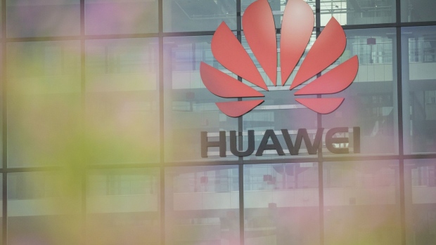 A Huawei Technologies Co. logo hangs above the entrance to the company's offices in Reading, U.K., on Monday, July 13, 2020. U.K. Prime Minister Boris Johnson is under pressure to announce a ban on telecoms companies from installing new equipment made by Huawei Technologies Co. in Britain's fifth-generation mobile networks from as soon as the end of 2021. Photographer: Jason Alden/Bloomberg