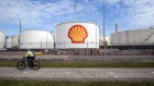 A cyclist passes oil silos at the Royal Dutch Shell Plc Pernis refinery in Rotterdam, Netherlands, on Tuesday, April 27, 2021. Shell reports first quarter earnings on April 29. Photographer: Peter Boer/Bloomberg