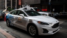 An Argo AI modified Ford Motor Co. Fusion autonomous vehicle stands ahead of a press conference in New York, U.S., on Friday, July 12, 2019. Volkswagen AG and Ford Motor Co. will cooperate on electric and self-driving car technology, sharing costs on a global scale to take a major step forward in the industry's disruptive transformation.