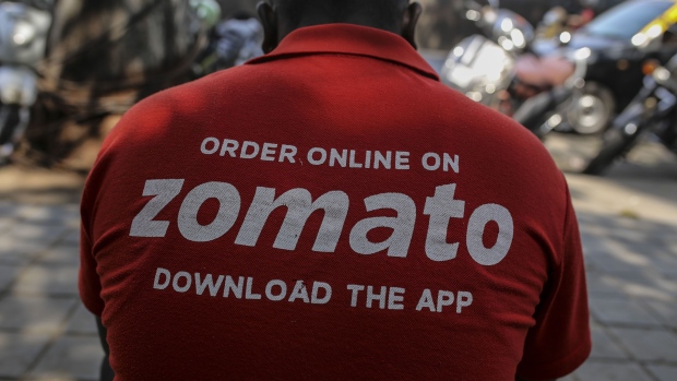 A Zomato food delivery courier rides a motorcycle carrying a customer order in Mumbai, India, on Tuesday, Jan. 21, 2020. Uber Technologies Inc. will sell Uber Eats in India to local rival Zomato in a $172 million deal, according to a person familiar with the transaction, underscoring the ride-hailing giant's effort to cut back on loss-making operations.