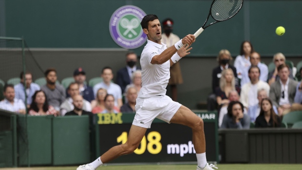 LONDON, ENGLAND - JULY 09: Novak Djokovic of Serbia plays a forehand in his Men's Singles Semi-Final match against Denis Shapovalov of Canada during Day Eleven of The Championships - Wimbledon 2021 at All England Lawn Tennis and Croquet Club on July 09, 2021 in London, England. (Photo by Clive Brunskill/Getty Images) Photographer: Clive Brunskill/Getty Images Europe
