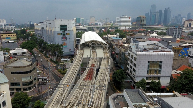 An elevated track for the Jakarta Mass Rapid Transit (MRT) rail system and Station Blok M stand among buildings in this aerial photograph taken in Jakarta, Indonesia, on Thursday, Jan. 31, 2019. Indonesia is scheduled to release fourth-quarter gross domestic product (GDP) figures on Feb. 6. Photographer: Dimas Ardian/Bloomberg