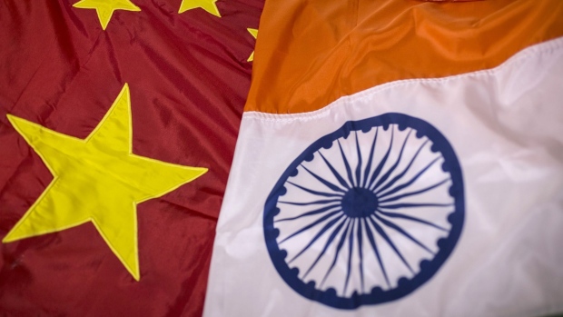 A Chinese national flag, left, and an Indian national flag are arranged for a photograph at FlagSource workshop in Mumbai, India, on Wednesday, June 24, 2020. Faced with disruptions to raw material supplies from China because of the pandemic and millions of job losses following a nationwide lockdown, Prime Minister Narendra Modi has ratcheted up calls to boost local manufacturing and reduce India’s reliance on imports. Photographer: Dhiraj Singh/Bloomberg