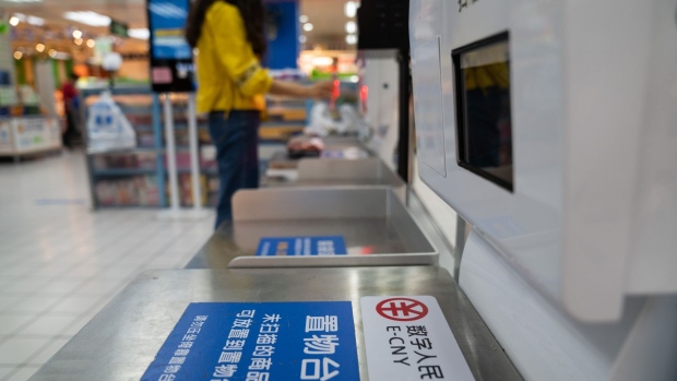 Signage for the digital yuan, also referred to as E-CNY, at a self check-out counter inside a supermarket in Shenzhen, China, on Friday, Nov. 20, 2020. The People's Bank of China is testing its digital money -- dubbed Digital Currency Electronic Payment, or DCEP -- in select cities, catapulting the world’s No. 2 economy to the forefront of a race to develop virtual money.