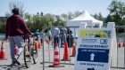Cyclists line up to register for a dose of the Pfizer-BioNTech Covid-19 vaccine at the Gilles Villeneuve racetrack in Montreal, Quebec, Canada, on Saturday, May 29, 2021. After the cancellation of this year's Grand Prix race, the track will administer vaccines at a rate of nearly 200 per hour for a total of 1,000 per day, The Montreal Gazette reports.