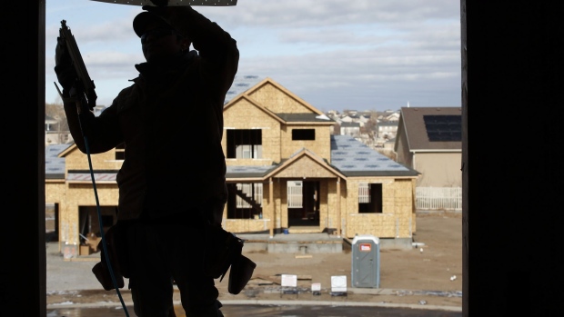 A contractor frames a house under construction in Lehi, Utah, U.S., on Wednesday, Dec. 16, 2020. Private residential construction in the U.S. rose 2.7% in November. Photographer: George Frey/Bloomberg