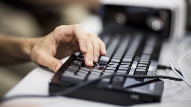 An attendee types on a keyboard during the MarketplaceLIVE Hackathon, sponsored by Digital Realty Trust Inc., in New York, U.S., on Thursday, Sept. 22, 2016. Digital Realty Trust's clients include domestic and international companies ranging from financial services, cloud and information technology services, to manufacturing, energy, gaming, life sciences and consumer products. Photographer: Bloomberg/Bloomberg