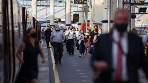 Commuters walk along a platform after arriving at London Waterloo railway station, on so-called 'Freedom Day', in London, U.K., on Monday, July 19, 2021. Boris Johnson's plan to get the U.K. back to normal is in disarray, with Covid-19 cases rising the most in the world and a public outcry over the prime minister's perceived attempt to dodge isolation rules. Photographer: Hollie Adams/Bloomberg