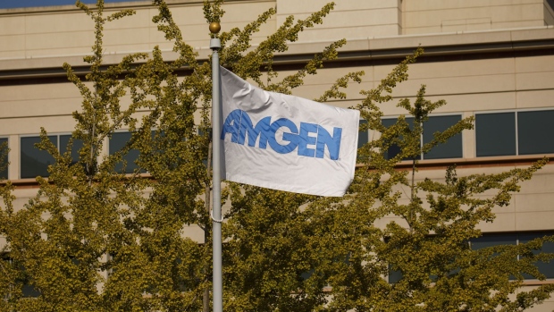 A branded flag flies outside Amgen Inc. headquarters in Thousand Oaks, California, U.S., on Thursday, Aug. 27, 2020. Amgen is among the world's biggest biotechnology companies with a market value of about $137 billion, though it's replacing a company -- Pfizer Inc. -- that is about $90 billion larger. Photographer: Patrick T. Fallon/Bloomberg