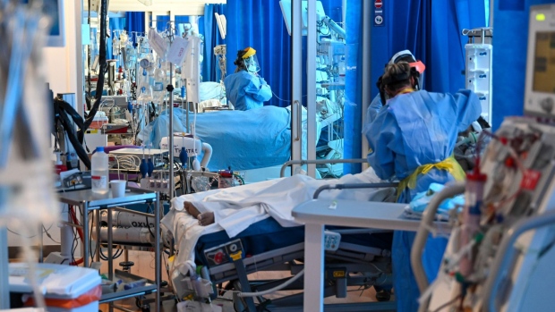 Clinical staff wear personal protective equipment (PPE) while caring for a patient in the Intensive Care unit (ICU) at the Royal Papworth Hospital, operated by the Royal Papworth Hospital NHS Foundation Trust, in Cambridge, U.K., on May 5, 2020. Photographer: Neil Hall/EPA/Bloomberg