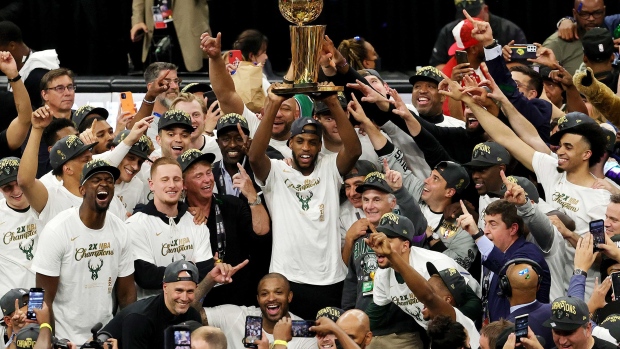 MILWAUKEE, WISCONSIN - JULY 20: Khris Middleton #22 and members of the Milwaukee Bucks celebrate after defeating the Phoenix Suns in Game Six to win the 2021 NBA Finals at Fiserv Forum on July 20, 2021 in Milwaukee, Wisconsin. NOTE TO USER: User expressly acknowledges and agrees that, by downloading and or using this photograph, User is consenting to the terms and conditions of the Getty Images License Agreement. (Photo by Jonathan Daniel/Getty Images)