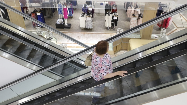 A customer rides an escalator inside a Shopper's Find location, a former Lord & Taylor store that went bankrupt last year, at the Willowbrook Mall in Wayne, New Jersey, U.S., on Monday, July 5, 2021. Shopper’s Find is sourcing directly from manufacturers or wholesalers stuck with piles of last season’s fashion and other extra goods as the retail industry regroups after the pandemic accelerated a monumental shakeout with more than 20 well-known retailers. Photographer: Angus Mordant/Bloomberg