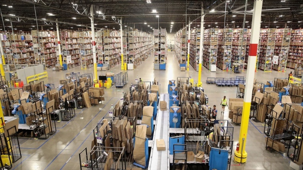 Workers pack and ship customer orders at the 750,000-square-foot Amazon fulfillment center on August 1, 2017 in Romeoville, Illinois. Photographer: Scott Olson/Getty Images