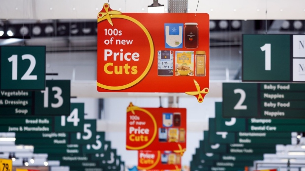 Signs advertising price cuts in a Morrisons supermarket, operated by Wm Morrison Supermarkets Plc, in Saint Ives, U.K., on Monday, July 5, 2021. Apollo Global Management Inc. said Monday it's considering an offer for Morrison, heating up a takeover battle for the U.K. grocer. Photographer: Chris Ratcliffe/Bloomberg