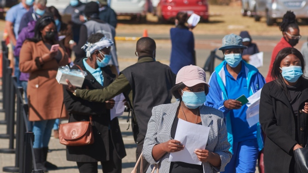 Residents wait in line to register outside a Discovery Ltd. mass vaccination site in the Midrand district of Johannesburg, South Africa, on Thursday, July 8, 2021. A third wave of coronavirus cases in South Africa’s commercial hub of Gauteng may have peaked after daily infections surged to a record last week. Photographer: Waldo Swiegers/Bloomberg