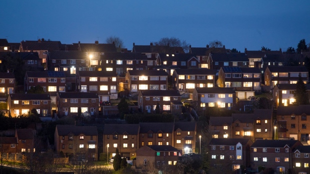 Lights illuminate the windows in residential properties in High Wycombe, U.K., on Monday, April 6, 2020. Among the decisions that my need to be made in U.K. Prime Minister Boris Johnson's absence are whether and when to tighten, extend or lift the current lockdown, which has seen all bars, restaurants and all non-essential shops closed, and people urged to work from home where they can. Photographer: Chris Ratcliffe/Bloomberg