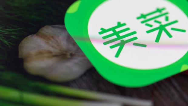 An icon for the Meicai application is displayed on a smart phone in an arranged photograph taken in Hong Kong, China, on Thursday, Jan. 11, 2018. Meicai, a China startup that helps farmers sell vegetables to restaurants, has raised $450 million in a funding round led by Tiger Global Management and China Media Capital, according to people familiar with the matter. Photographer: Justin Chin/Bloomberg