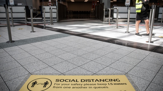 A social distancing sign sits on the ground inside the departures terminal at Liszt Ferenc airport in Budapest, Hungary, on Monday, May 25, 2020. Wizz Air is plotting a major expansion at London Gatwick airport as rival carriers pull back, paving the way for the Hungarian low-cost carrier to emerge from the travel downturn with a bigger presence in the world’s busiest city for passenger traffic. Photographer: Akos Stiller/Bloomberg