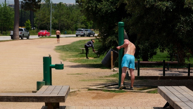 A runner cools off under an outdoor shower on the trail at Memorial Park in Houston, Texas, on June 15.