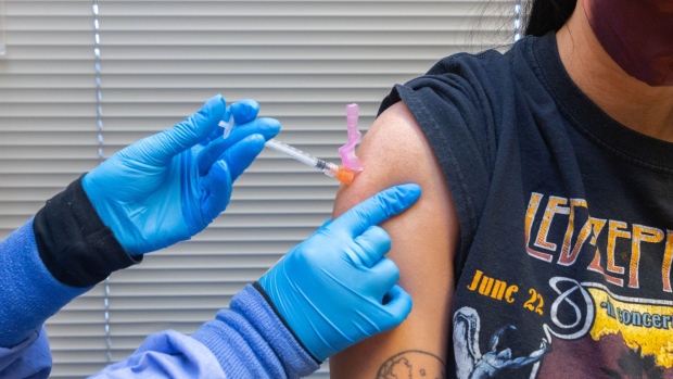 A healthcare worker administers a dose of the Pfizer-BioNTech Covid-19 vaccine to a resident at the Jordan Valley Community Health Center in Springfield, Missouri, U.S., on Tuesday, June 29, 2021. President Biden set a goal for 70% of American adults to get at least one Covid-19 shot by July 4. Despite ample vaccine supplies he missed that target, largely because the government has struggled to give away shots in rural, deeply conservative regions that are bastions of support for his predecessor. Photographer: Liz Sanders/Bloomberg