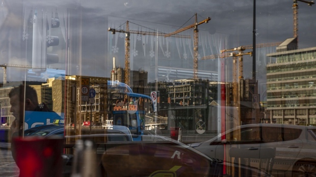 A window reflects construction cranes on the skyline of the River Liffey in Dublin, Ireland, on Monday, Jan. 6, 2020. Ireland issued a record number of passports in 2019 as applications from its citizens in the U.K. surged amid Brexit uncertainty. Photographer: Hollie Adams/Bloomberg