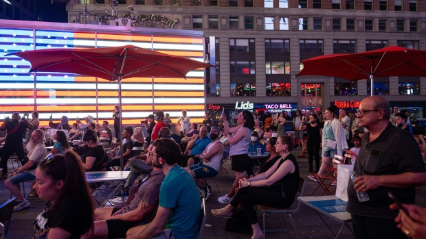People watch ‘The Ninth Hour’ by Shayfer James and Kate Douglas as part of the UP UNTIL NOW Collective: ‘Georgia’ in Times Square on July 20, 2021 in New York City. Photographer: Alexi Rosenfeld/Getty Images
