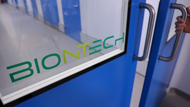 A BioNTech SE logo on the entrance to the company's Covid-19 vaccine production laboratory in Marburg, Germany, on Saturday, March 27, 2021. BioNTech and Pfizer Inc. raised this year’s production target for their Covid-19 vaccine to as many as 2.5 billion doses, with the German biotech’s chief executive predicting a version of the shot that can be stored in refrigerators will be ready within months. Photographer: Cyril Marcilhacy/Bloomberg