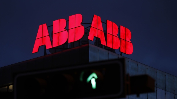 An illuminated logo stands on the roof of an ABB Ltd. plant at night in Baden, Switzerland. Photographer: Stefan Wermuth/Bloomberg